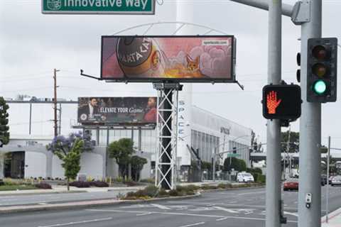 SpartaCats Troll Doge a Billboard Advertising PURR Meme Coin in front of the Tesla & SpaceX Office